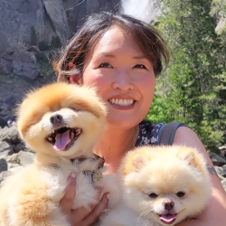 woman holding two pomeranians